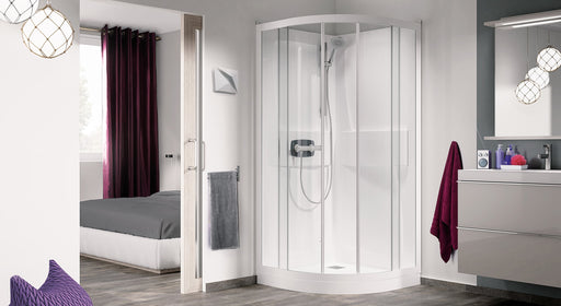 Cabina de ducha curva Kinedo Kineprime con puertas correderas y plato blanco, instalada en una esquina